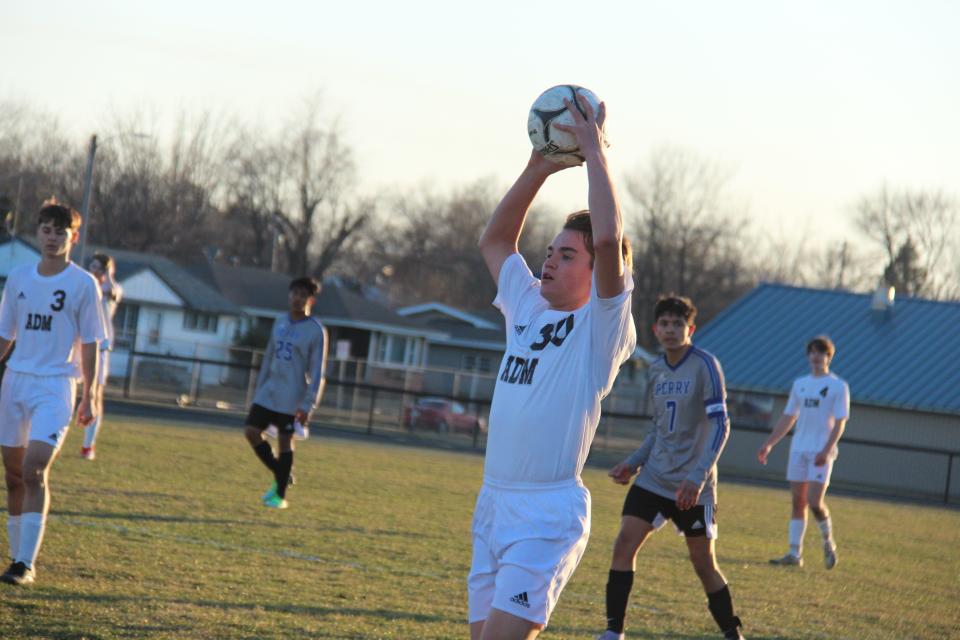 ADM's Miles Chesney gets set to pass the ball in to a teammate on Monday, April 4, 2022, in Perry.