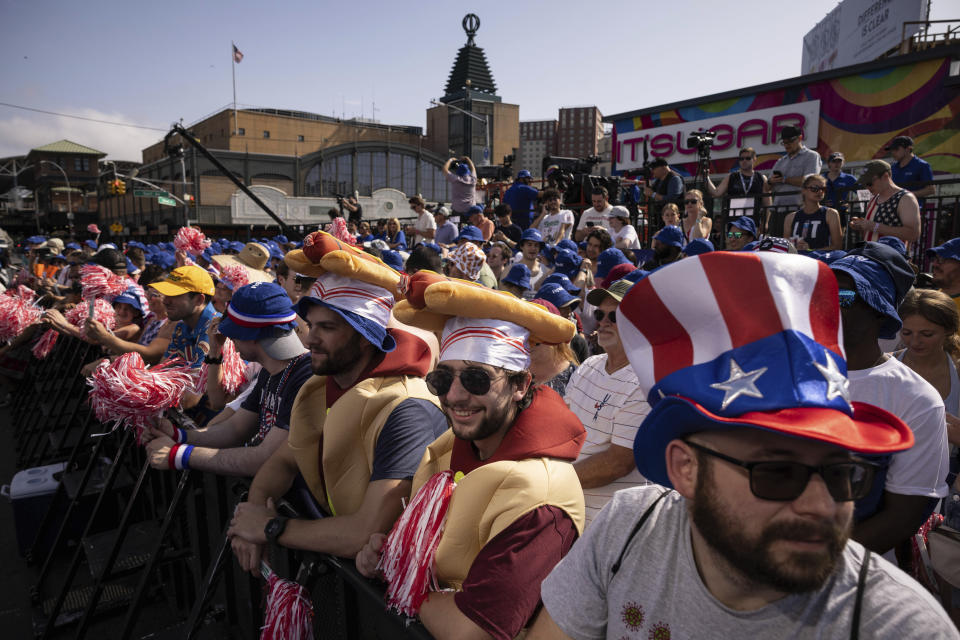 People gather ahead of the 2023 Nathan's Famous Fourth of July hot dog eating contest in the Coney Island section of the Brooklyn borough of New York, Tuesday, July. 4, 2023. (AP Photo/Yuki Iwamura)