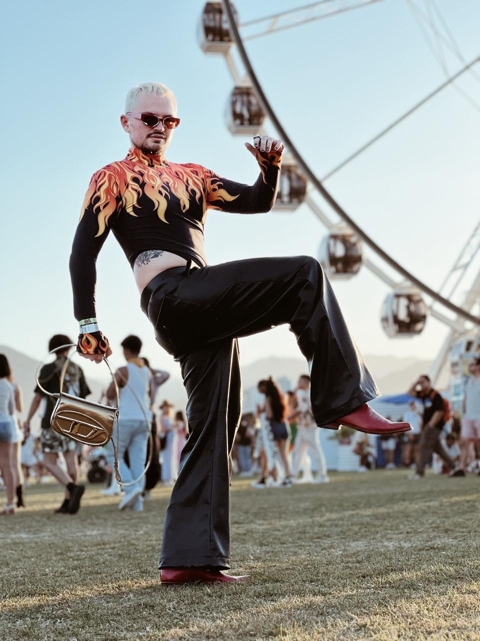 Christian Grotewold posing for photo in flame top at coachella music festival