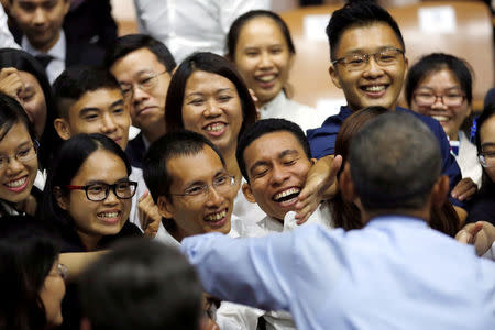 U.S. President Barack Obama greets members of the audience during a town hall meeting with members of the Young Southeast Asian Leaders Initiative (YSEALI) at the GEM Center in Ho Chi Minh City, Vietnam May 25, 2016. REUTERS/Carlos Barria