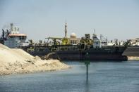 Egyptian workers expand the Suez Canal near the port city of Ismailia, east of Cairo, on July 29, 2015