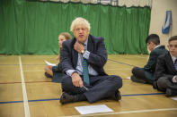 Prime Minister Boris Johnson with Olivia Stokes in the gym taking part in a getting to know you induction session with year sevens as he tours Castle Rock school, Coalville, in the east Midlands.