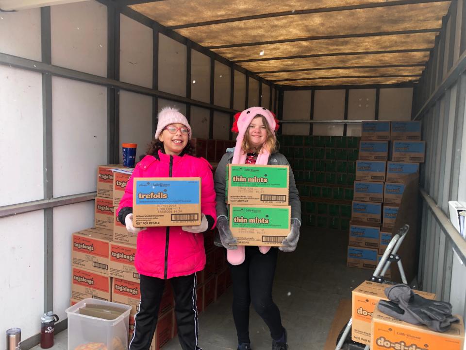 Zoe Gladitz, 12, of Girl Scout Trop #3041, and her fellow troop member Arialynn Morrison, 10, help folks load up their Girl Scout cookie orders on a frigid day Feb. 24.