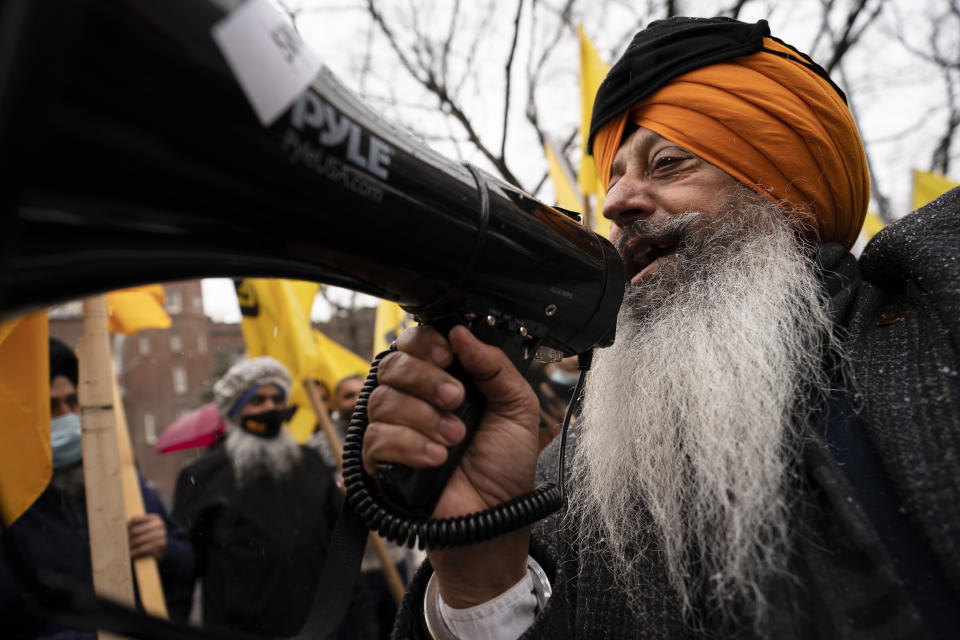 Protesters lead chants outside the Consulate General of India, Tuesday, Jan. 26, 2021, in the Manhattan borough of New York. Tens of thousands of protesting farmers have marched, rode horses and drove long lines of tractors into India's capital, breaking through police barricades to storm the historic Red Fort. The farmers have been demanding the withdrawal of new laws that they say will favor large corporate farms and devastate the earnings of smaller scale farmers. Republic Day marks the anniversary of the adoption of India’s constitution on Jan. 26, 1950. (AP Photo/John Minchillo)