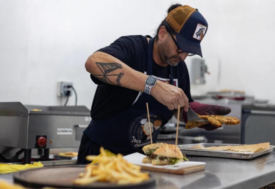 Christian Fernandez, co-owner of Karnitas 71st, prepares a plate of Mila Messi, a Lionel Messi-themed dish consisting of breaded chicken breast topped with fried eggs and french fries on Tuesday, July 12, 2023 in Miami Beach.