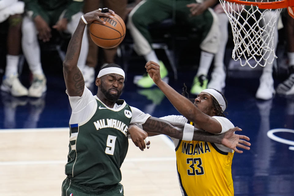 Milwaukee Bucks forward Bobby Portis (9) grabs a rebound in front of Indiana Pacers center Myles Turner (33) during the second half in Game 2 in an NBA basketball first-round playoff series, Friday, April 26, 2024, in Indianapolis. (AP Photo/Michael Conroy)