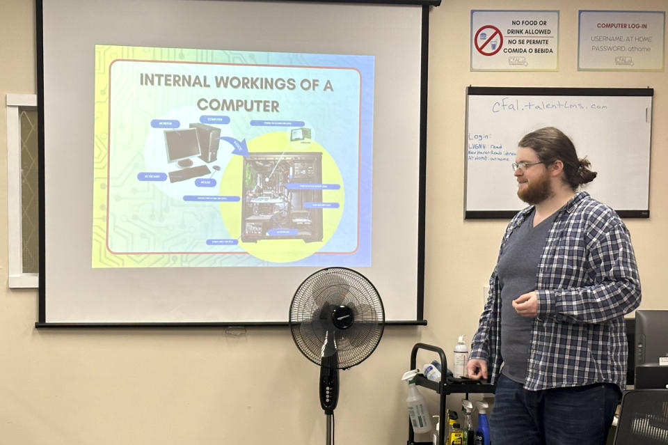 In this undated photo, Richie Hull, a lead instructor at the Connecticut-based group CfAL for Digital Inclusion, teaches the Foundation to a Career in Computers class at the organization's computer lab in New Haven, Conn. States are looking to beef up their residents tech skills as generative artificial intelligence plays a greater role in the workplace. CfAL officials, however, say basic computer skills are also still needed. (Rose Servetnick/CfAL for Digital Inclusion via AP)