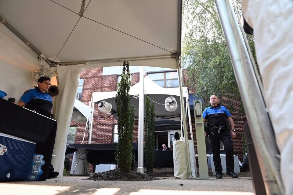 Police officers stand in the check-in area of the temporary outdoor space set up outside the Greenville Municipal Court on Monday in Greenville, S.C.