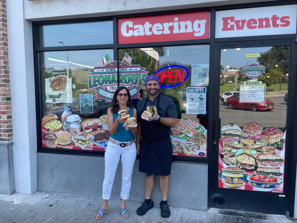 Lohud Food &  Dining Reporter Jeanne Muchnick, left, with Frank Ficarra, owner of Leonardo's Deli & Catering in New City. The deli is known for its long list of sandwiches. Photographed July 25, 2023