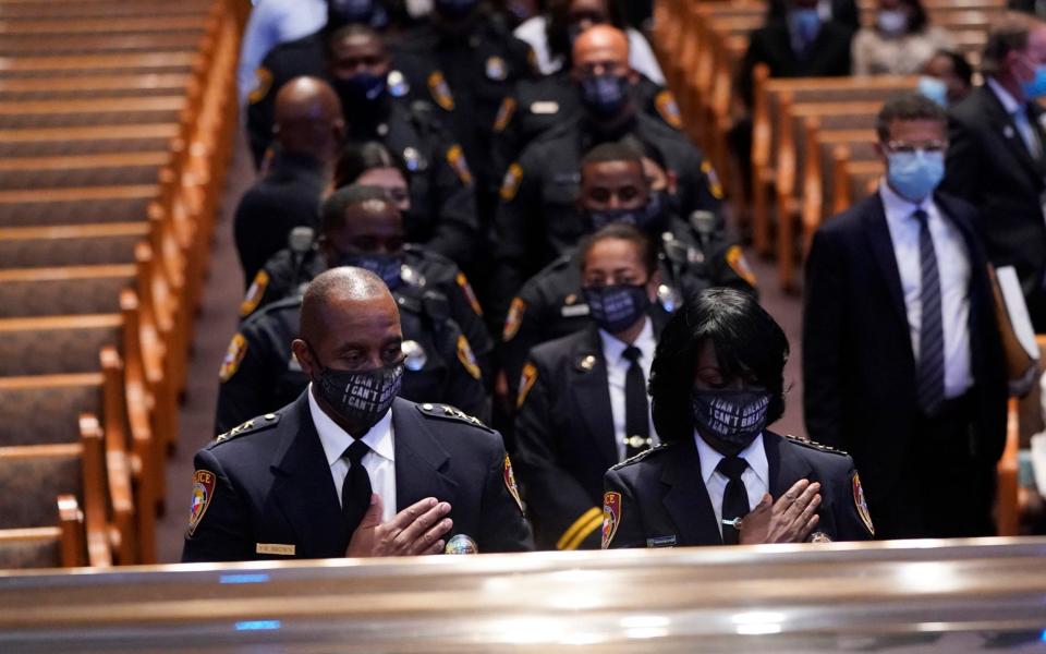 Members of the Texas Southern University police department pause during a funeral service for George Floyd at The Fountain of Praise church - AP