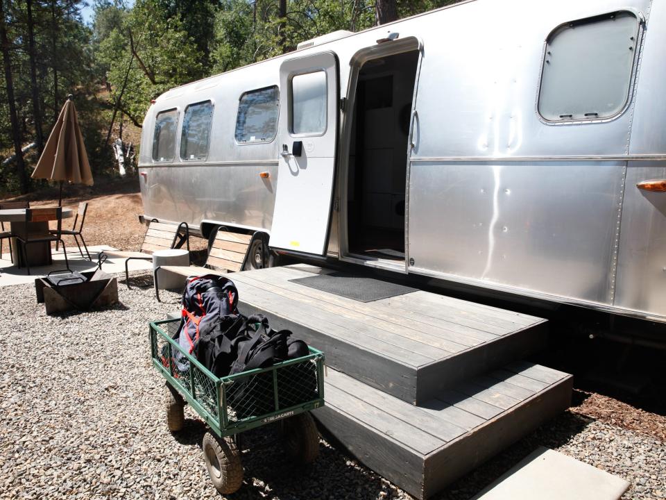 the exterior of the Airstream with a wagon of my bags