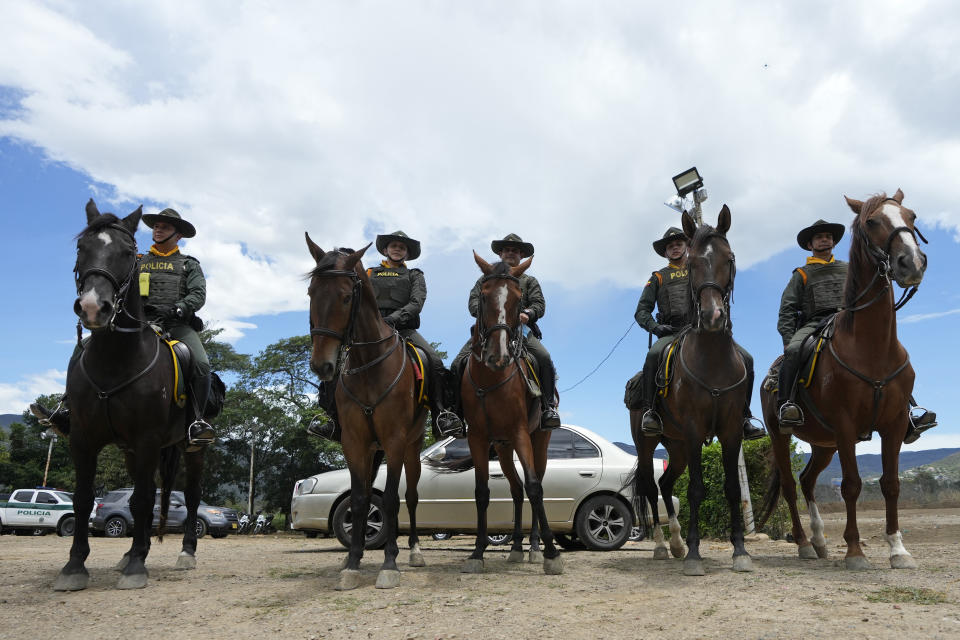 Colombian mounted police stand guard near the Simon Bolivar International Bridge during a ceremony marking its reopening to cargo trucks, between Cucuta, Colombia and San Antonio del Tachira, Venezuela, Monday, Sept. 26, 2022. Vehicles with merchandise will cross the bridge on Monday in a ceremonial act to seal the resumption of commercial relations between the two nations. (AP Photo/Fernando Vergara)