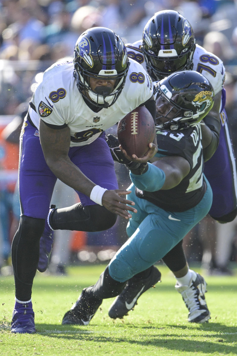 Baltimore Ravens quarterback Lamar Jackson (8) scrambles for yardage against Jacksonville Jaguars linebacker Foyesade Oluokun (23) during the second half of an NFL football game, Sunday, Nov. 27, 2022, in Jacksonville, Fla. (AP Photo/Phelan M. Ebenhack)