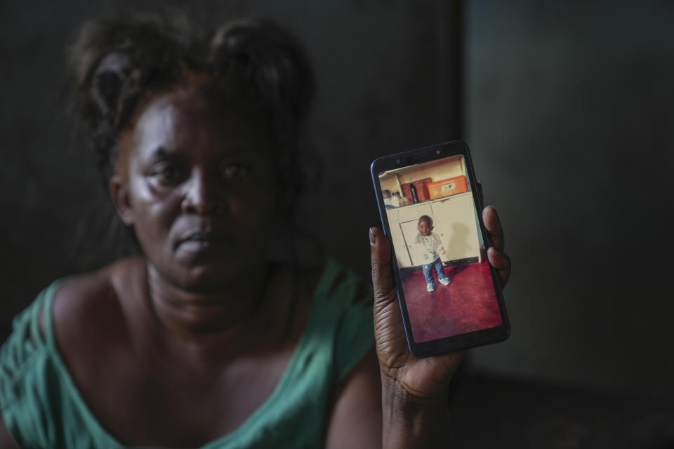 Mildred Banda holds a phone showing a picture of her one-year-old son who died of Cholera in Lilanda township in Lusaka, Zambia, Saturday, March, 9, 2024. Lilanda, an impoverished township on the edge of the Zambian capital of Lusaka, is a typical cholera hotspot. Stagnant pools of water dot the dirt roads. Clean water is gold dust. Extreme weather events have hit parts of Africa relentlessly in the last three years, with tropical storms, floods and drought causing crises of famine and displacement, and leaving another deadly threat in their aftermath: some of the continent's worst outbreaks of cholera. (AP Photo/Tsvangirayi Mukwazhi)