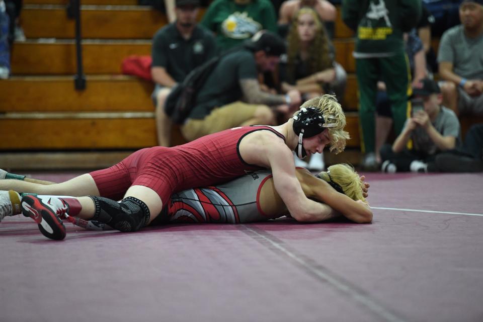 Lake Gibson's Elijah Lowe takes the fight to East River's Pedro Sifuentes. Lowe won a regional championship after a 6-1 decision.