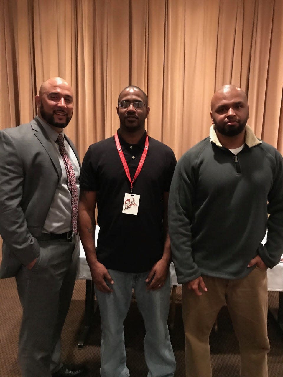 Former McKinley football standouts (from left) Andre Hooks, James Gamble and Matt Curry, who helped the Bulldogs win a 1997 national championship, pose for a photo together in 2017.