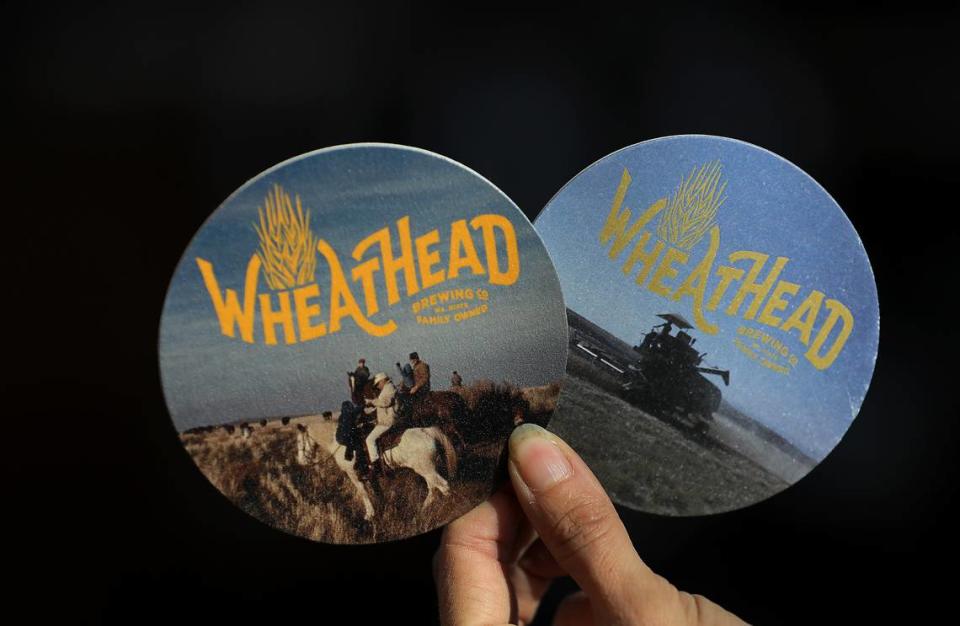 Phillips and Miller used old family photos from early farm life for the coasters they will use in their new Wheat Head Brewery. Bob Brawdy/bbrawdy@tricityherald.com