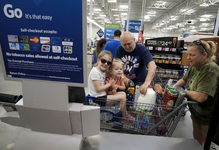 A family uses the self-checkout at the Wal-Mart owned Sam's Club in Bentonville, Arkansas June 4, 2015. REUTERS/Rick Wilking