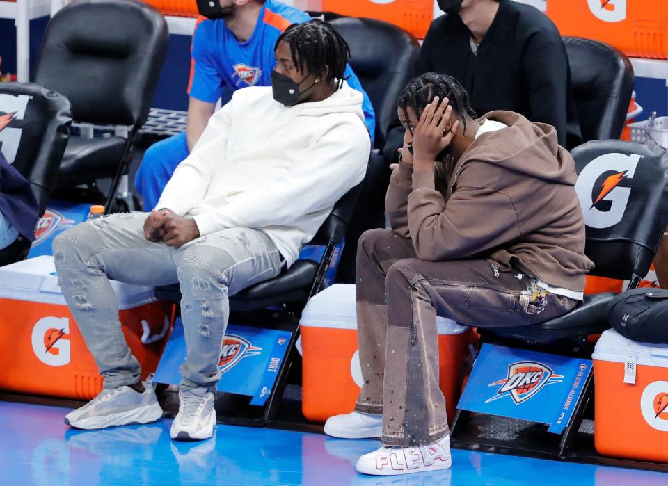 Oklahoma City Thunder forward Luguentz Dort (left) and guard Shai Gilgeous-Alexander (right) watch as their team takes on the Indiana Pacers.