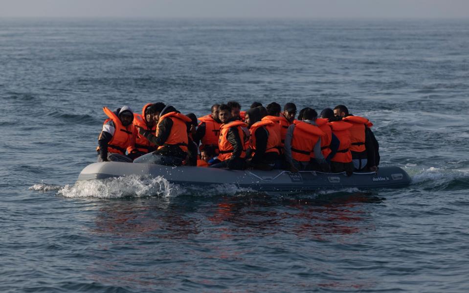 An inflatable craft with migrant men, women and children aboard in the Channel earlier this month - Dan Kitwood/Getty Images