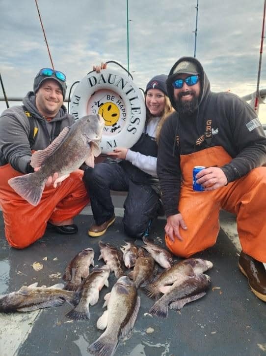The Grumpy Tackle crew, Ray Kerico, left, Jenni Ackerman, center and Sean Smida, right, with their catch of blackfish on the Dauntless party boat.