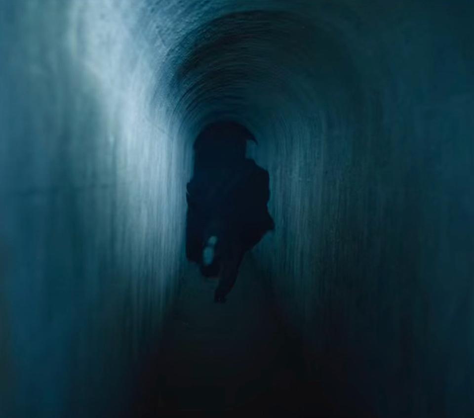 someone runs away in an underground tunnel in "the watcher"