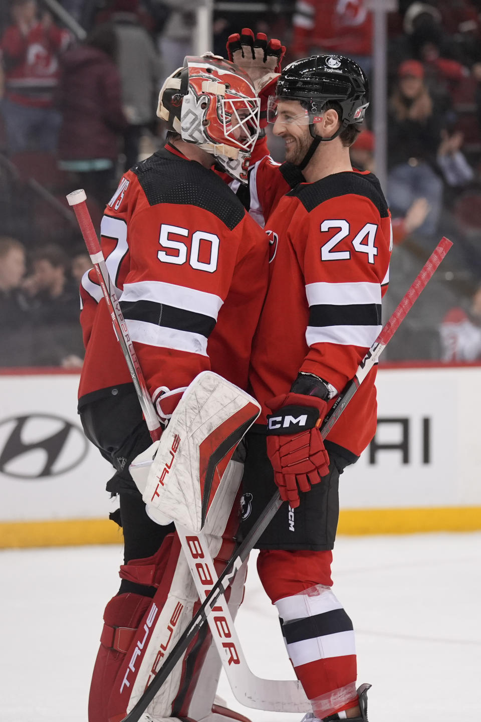 New Jersey Devils goaltender Nico Daws, left, and Colin Miller celebrate after an NHL hockey game against the Seattle Kraken in Newark, N.J., Monday, Feb. 12, 2024. (AP Photo/Seth Wenig)