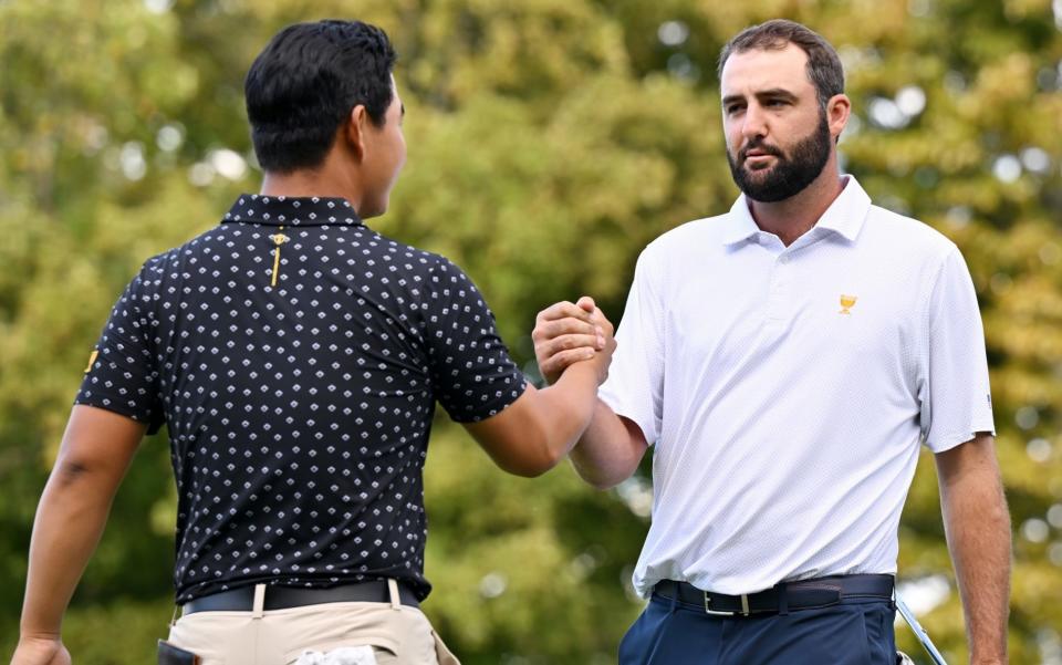 Tom Kim of South Korea and the international team and Scottie Scheffler of the US team shake hands after Scheffler and Russell Henley defeated Kim and Sungjae Im 3&2 during Thursday's four-ball matches on day one of the 2024 Presidents Cup at Royal Montreal Golf Club on September 26, 2024 in Montreal