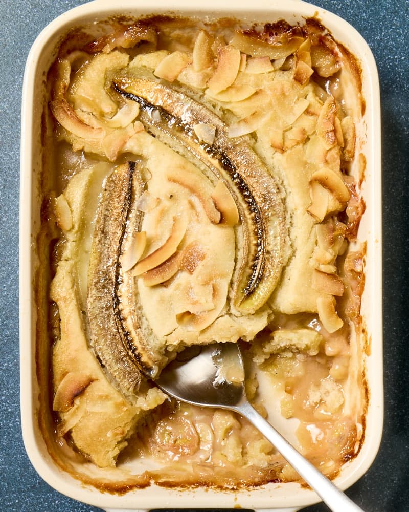 overhead shot of a banana cobbler with a large scoop taken out of the bottom right corner.