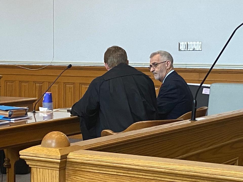 Robert Regular speaks with his defence lawyer Jerome Kennedy at Newfoundland and Labrador Supreme Court on Wednesday. (Rob Antle/CBC - image credit)