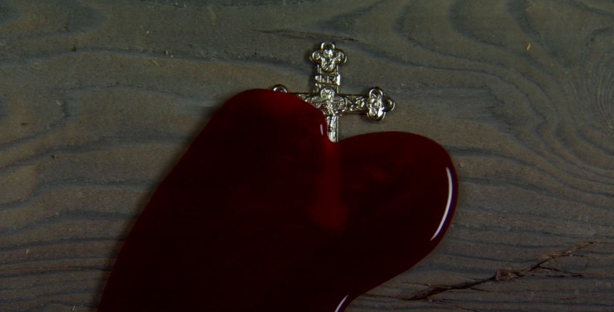 blood pooling over an ornate cross