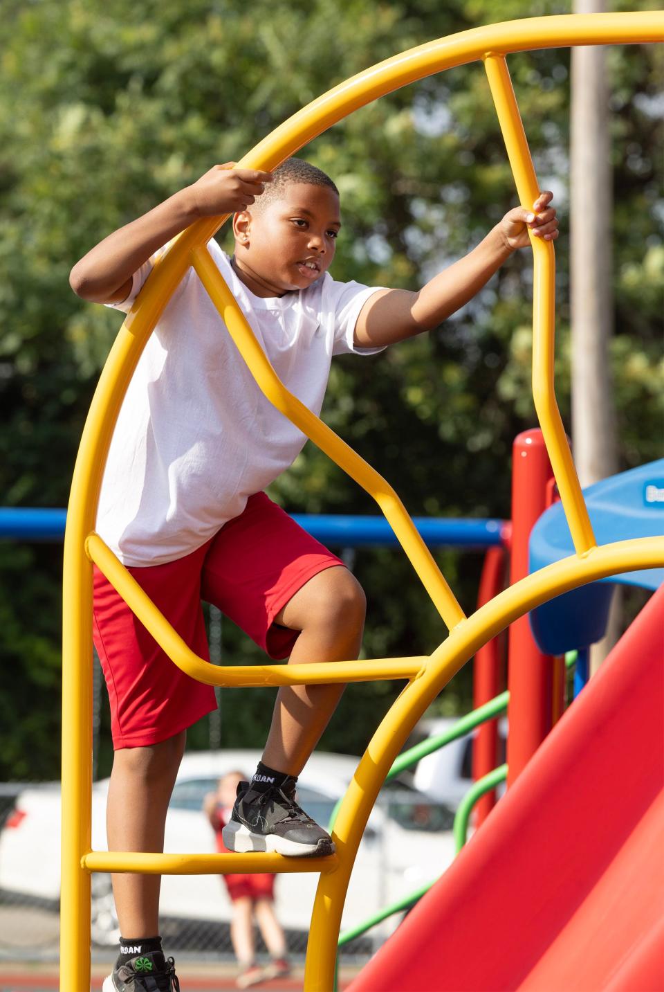 Jase Snow, 8, plays on the new Southeast Community Playground equipment at the Habitat for Humanity dedication celebration in Canton.