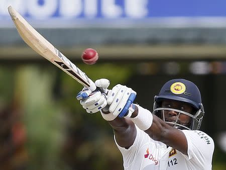 Sri Lanka's captain Angelo Mathews plays a shot during the second day of their second test cricket match against Pakistan in Colombo June 26, 2015. REUTERS/Dinuka Liyanawatte