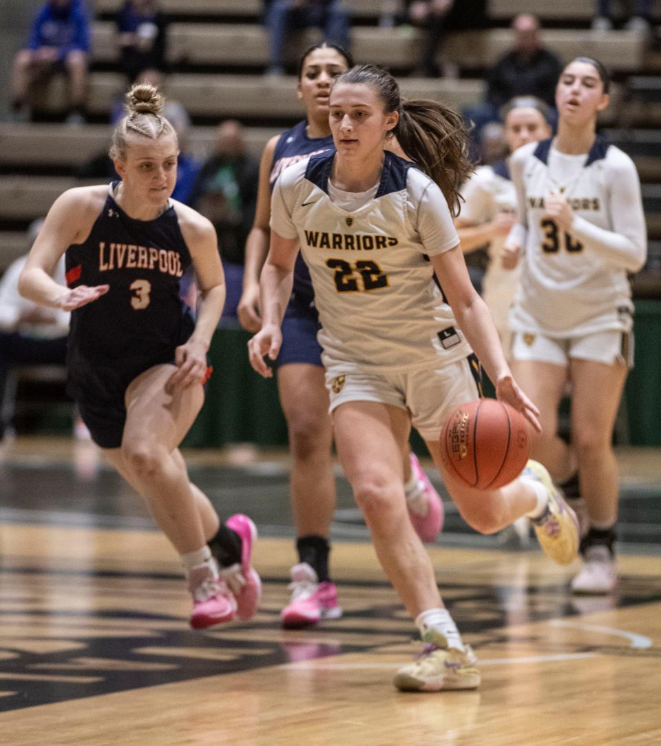 Lourdes' Simone Pelish drives for two of her game-high 33 points in her team's win over Liverpool in the Class AAA girls basketball state final on March 17, 2024.