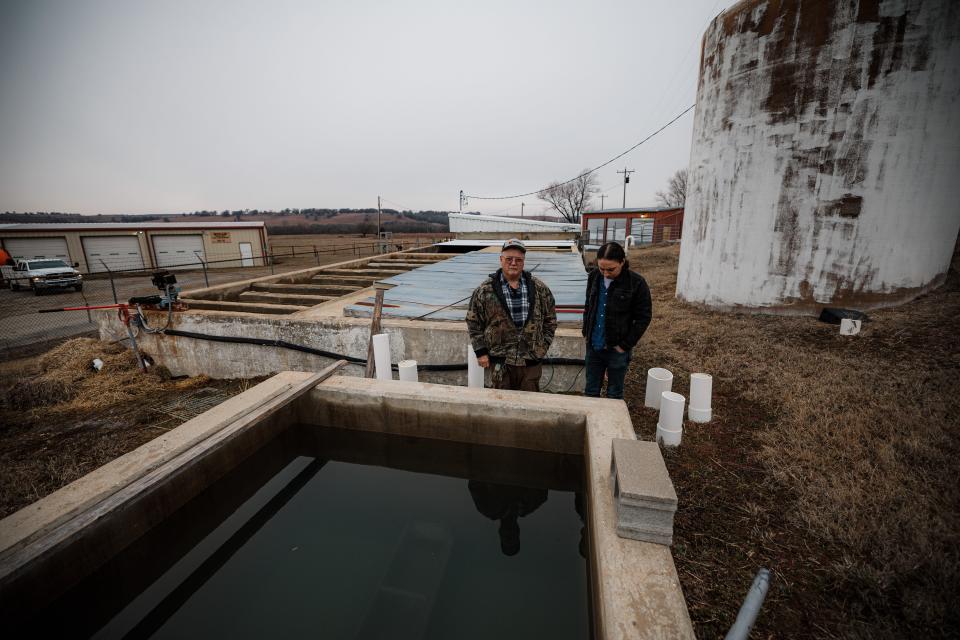 Osage County Rural Water District #20 operators Jim Edens and Joseph Rosette stand in front of the treatment plant's sand filter.