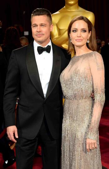 Brad Pitt (L) and actress Angelina Jolie attend the Oscars held at Hollywood &amp; Highland Center on March 2, 2014 in Hollywood, California