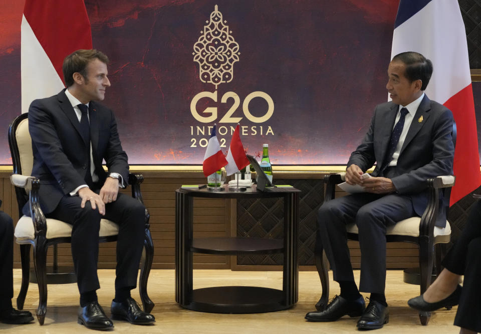 French President Emmanuel Macron, left, and Indonesia President Joko Widodo meet during the G20 leaders' summit in Nusa Dua, Bali, Indonesia on Tuesday Nov. 15, 2022. (AP Photo/Achmad Ibrahim, Pool)