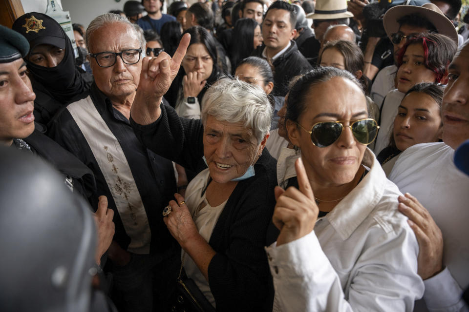 Gloria Valencia and Lorena Villavicencio, the mother and sister of presidential candidate Fernando Villavicencio, arrive for the funeral at Camposanto Monteolivo cemetery in Quito, Ecuador, Friday, Aug. 11, 2023. The 59-year-old was fatally shot at a political rally on Aug. 9 in Quito. (AP Photo/Carlos Noriega)