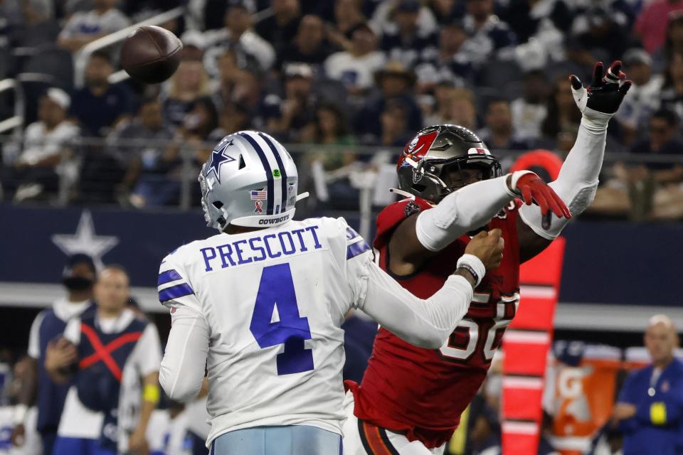 Dallas Cowboys quarterback Dak Prescott (4) is hit by Tampa Bay Buccaneers linebacker Shaquil Barrett (58) while throwing a pass in the second half of a NFL football game in Arlington, Texas, Sunday, Sept. 11, 2022. (AP Photo/Michael Ainsworth)