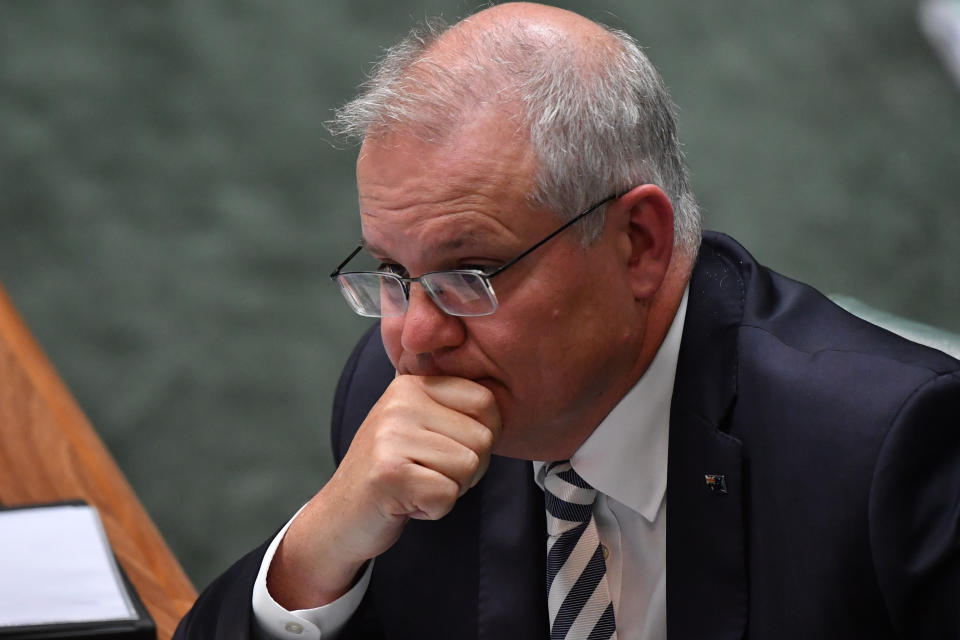 CANBERRA, AUSTRALIA - MARCH 25: Prime Minister Scott Morrison reacts during Question Time in the House of Representatives at Parliament House on March 25, 2021 in Canberra, Australia. The federal government was on Monday set back by new allegations broadcast by the Ten Network after pixelated images of unnamed Coalition advisers allegedly engaging in performing lewd sex acts on the desks of female MPs resulting in a Morrison staff member being sacked last night. Additionally, the ABC Network aired a first hand account by an Australian Parliament security guard of what she witnessed on the night Brittany Higgins was allegedly raped in the office of then-defence industry minister Linda Reynolds in early 2019. (Photo by Sam Mooy/Getty Images)