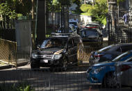 Federal police leave Laranjeiras Palace, the official residence of Rio de Janeiro Gov. Wilson Witzel, in Rio de Janeiro, Brazil, Tuesday, May 26, 2020. Brazil's Federal Police raided the governor's official residence on Tuesday to carry out searches, part of an investigation into the embezzlement of public resources in the state's response to the COVID-19 pandemic. (AP Photo/Silvia Izquierdo)