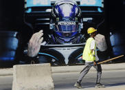 A road crew works on a road outside the Formula One corniche circuit, in Jiddah, Saudi Arabia, Sunday, Nov. 21, 2021. Next month's F1 race will be the first time Saudi Arabia hosts the premier sporting event, though the kingdom has hosted the lesser known Formula-E race in past years in an effort to raise the country's profile as a tourist destination. (AP Photo/Amr Nabil)