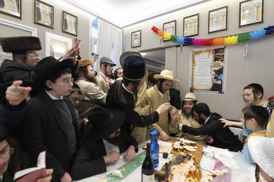 FILE - Ultra-Orthodox Jewish men and children, some in costumes, celebrate the Jewish holiday of Purim in Mea Shearim ultra-Orthodox neighborhood in Jerusalem, March 8, 2023. Purim celebrates the biblical story of how a plot to exterminate Jews in Persia was thwarted, and thus is embraced as an affirmation of Jewish survival throughout history. For many Jews, it will have extra significance in 2024 during a war in Gaza triggered by the Oct. 7, 2023, attacks on Israel in which Hamas killed 1,200 people and took about 250 others hostage. (AP Photo/Ohad Zwigenberg, File)