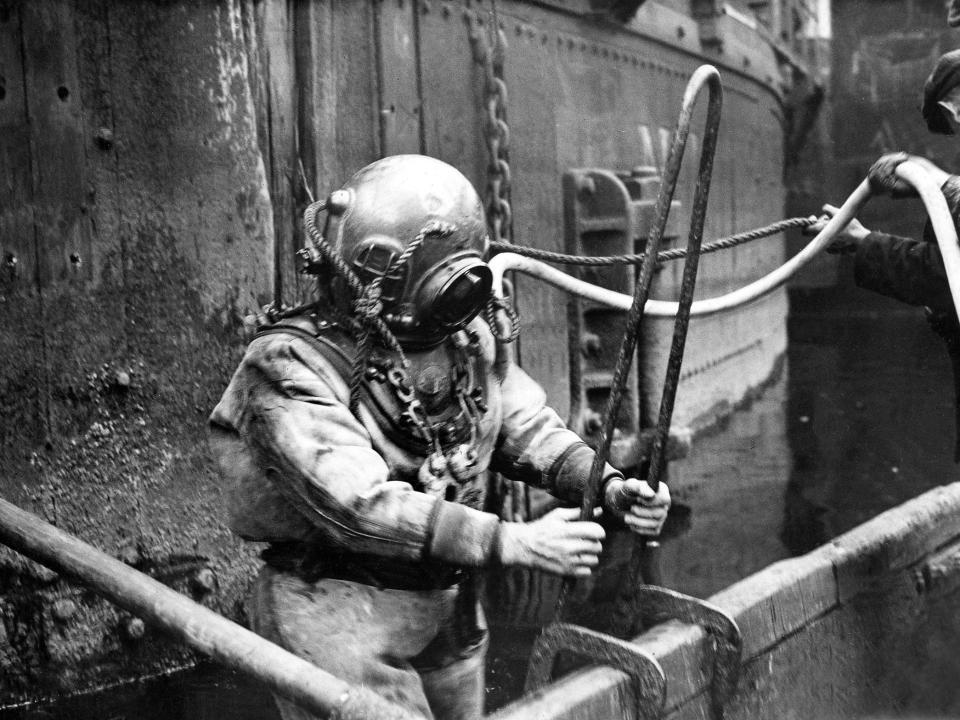 A diver prepares himself before a dive, circa 1940.