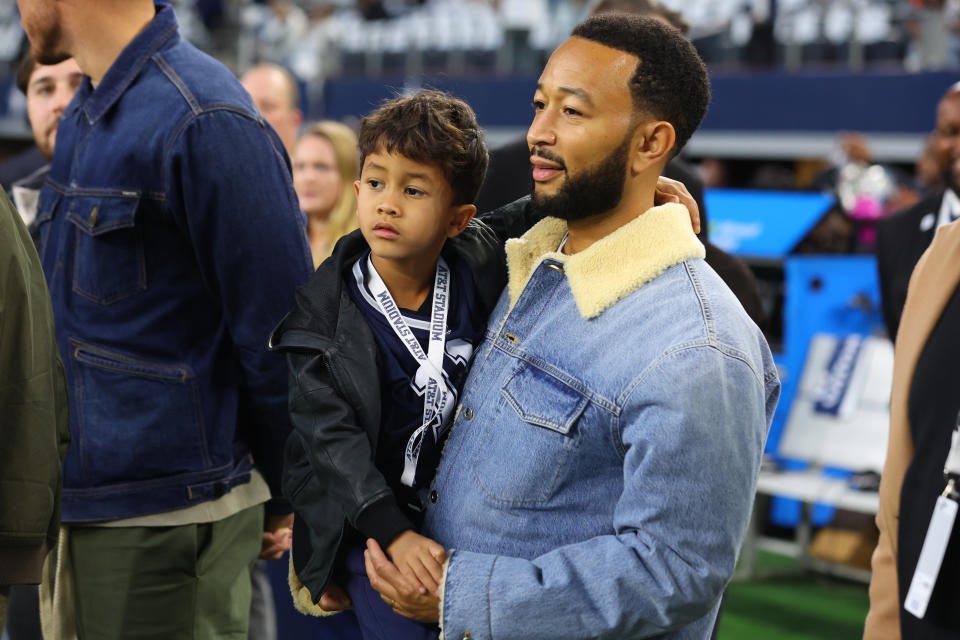 ARLINGTON, TEXAS - DECEMBER 10: Musician John Legend is seen on the field with his son prior to a game between the Dallas Cowboys and the Philadelphia Eagles at AT&T Stadium on December 10, 2023 in Arlington, Texas. (Photo by Richard Rodriguez/Getty Images)