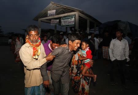 Villagers from Muslim communities wail upon seeing the body of a relative at a relief camp in Narayanguri village in Baksa district in Assam May 4, 2014. REUTERS/Utpal Baruah