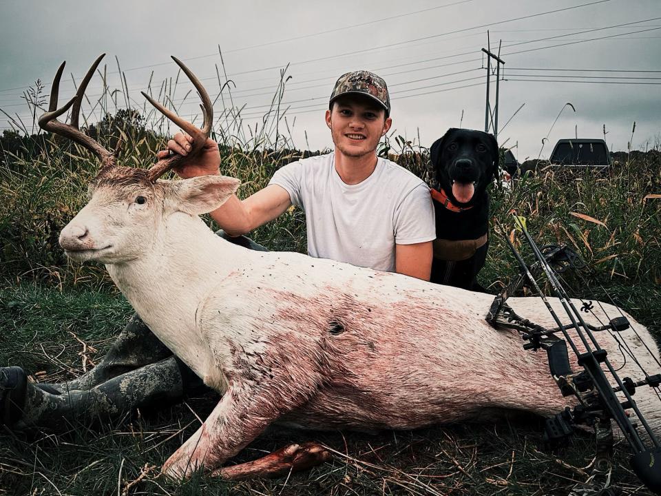 Goeppner poses with the rare trophy alongside his black lab Nelli.