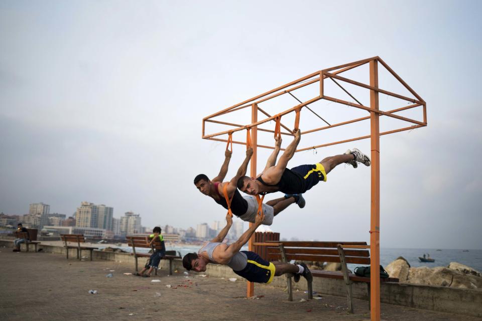 Palestinian group, Bar Palestine, take part in street exercises on the coast of Gaza City on August 3, 2015. Street workout, that is still new to Gaza, is a growing sport across the world with annual competitions and events.