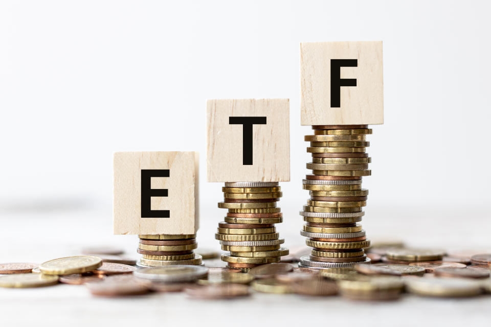 Exchange Traded Fund (ETF) concept. Wooden cube standing with 