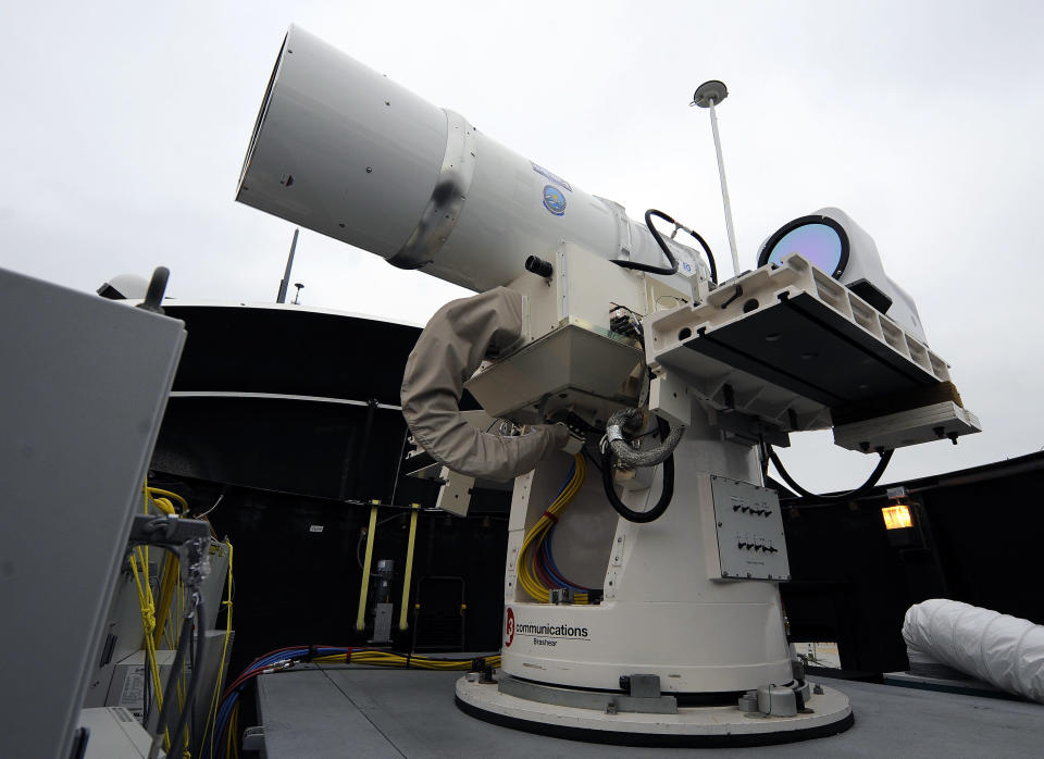 <p> In this July 30, 2012 photo provided by the U.S. Navy, a laser weapon sits temporarily installed aboard the guided-missile destroyer USS Dewey in San Diego. The Navy plans to deploy its first laser on a ship in 2014, and intends to test an electromagnetic rail gun prototype aboard a vessel within the following two years. (AP Photo/U.S. Navy, John F. Williams) </p>